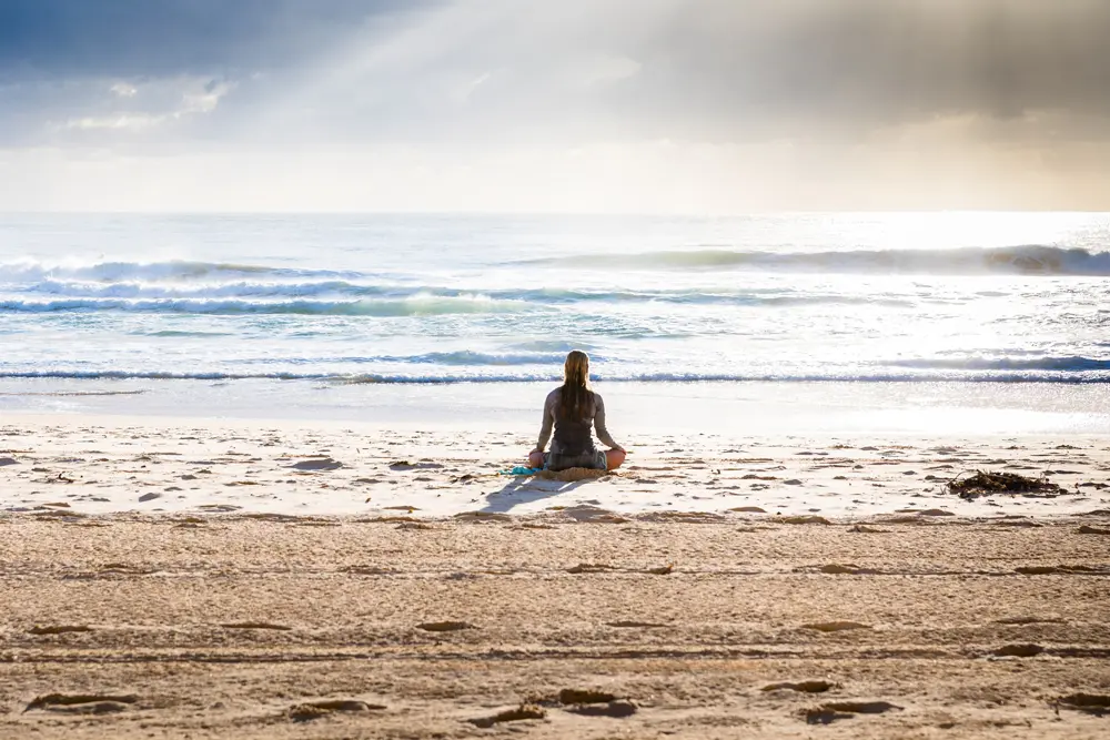 Premium Photo | Young healthy yoga woman practicing yoga pose on the beach  at sunrise